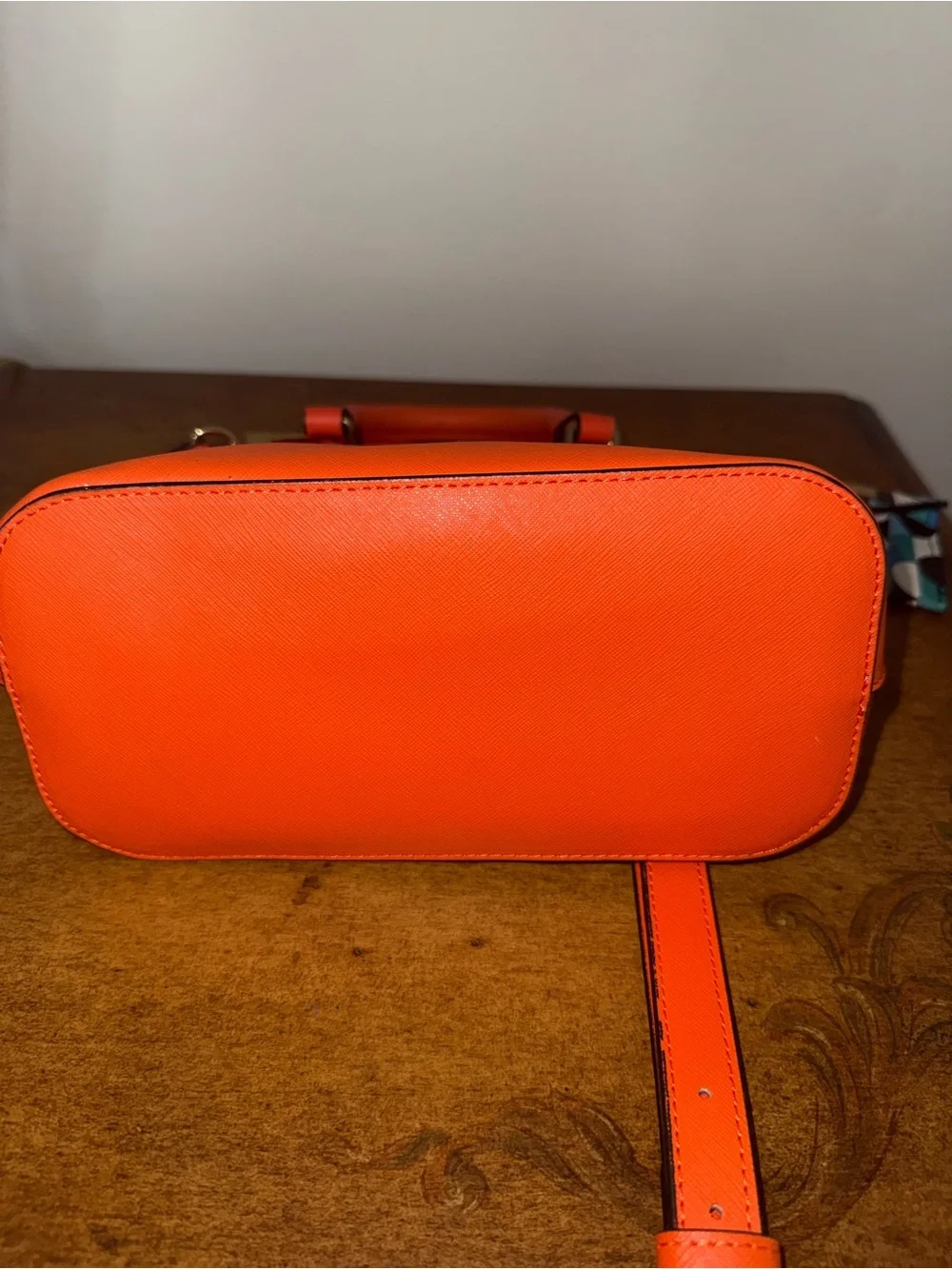 Trina Turk Dome Satchel Handbag in a vibrant, sunset orange.